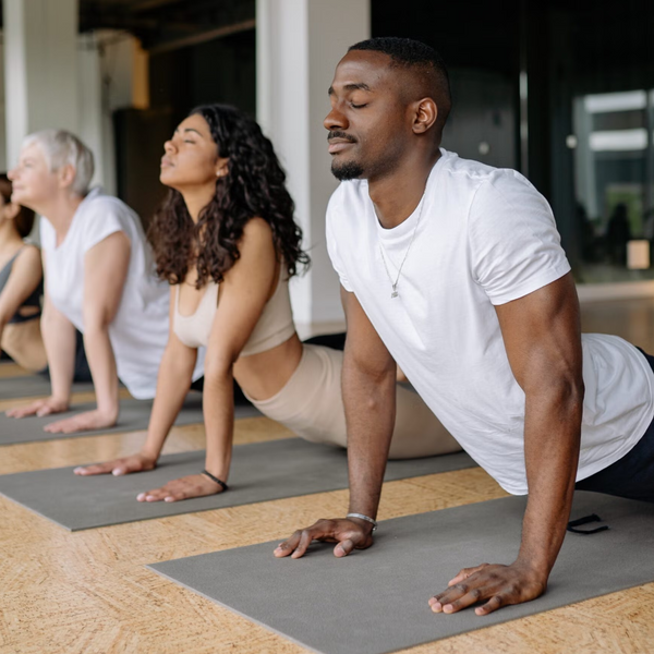 Group of people practicing yoga in a studio setting