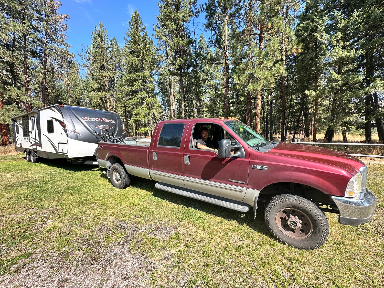 Miles sitting in a pickup truck, towing a travel trailor